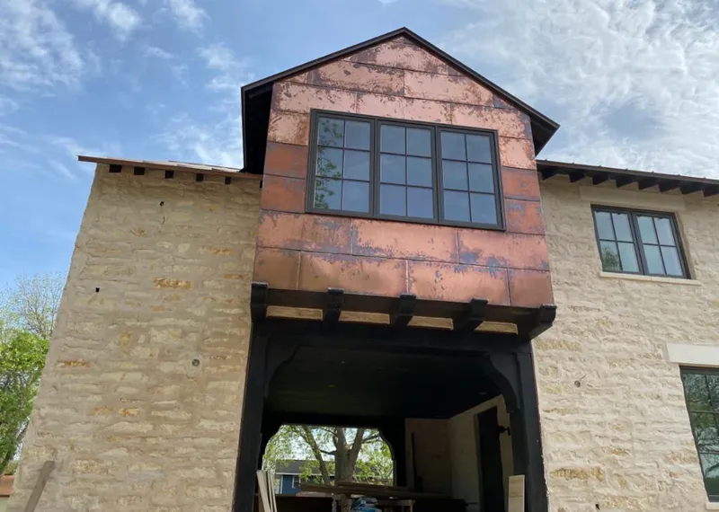 Copper metal panel facade on a stone building for Skylight Installation in Dinuba